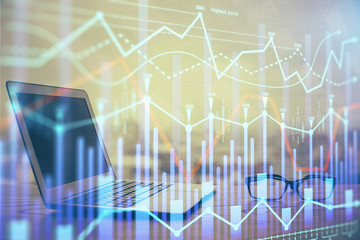 Stock market chart hologram drawn on personal computer background. Double exposure. Concept of investment.