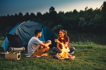 Wall Mural - romantic couple on camping by the river outdoors