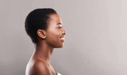 Wall Mural - Profile portrait of woman with perfect skin and white teeth