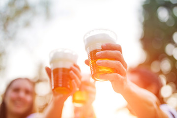 Friends enjoying drinking beer in the backyard.