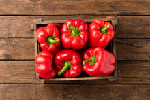 Overhead Shot Of Red Bell Pepper In Box On Vintage Wooden Table With Copyspace. Sweet Paprika