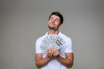 Poster - Dreaming man posing isolated over grey wall