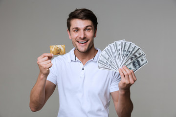 Poster - Optimistic man holding money and debit card.