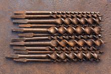 Vintage Drills Background, Old Brace Bits Aligned On Rusted Steel Plate, Patina.