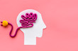© 9dreamstudio - Brain charging and mental rest. Plug and cable leads to plastiline meanders on pink background top view copy space