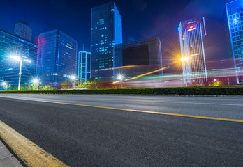 empty urban road with modern building at night