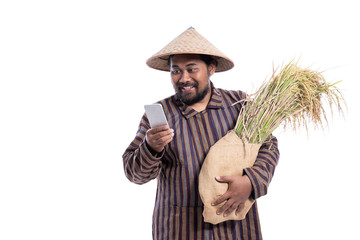 Wall Mural - asian farmer using mobile phone isolated over white background