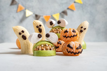 Healthy Fruit Halloween Treats. Banana Ghosts, Clementine Orange Pumpkins And Apple Monster Mounts