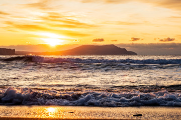 Wall Mural - picturesque sunrise over the Black Sea, waves roll on the sand