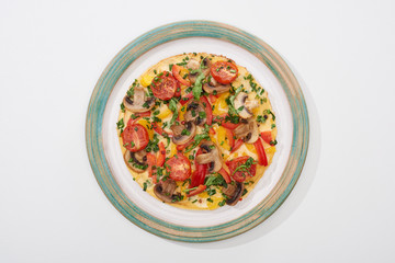 top view of plate with tasty omelet for breakfast on white table