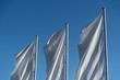 Leinwandbild Motiv Wehende Flaggen vor blauem Himmel