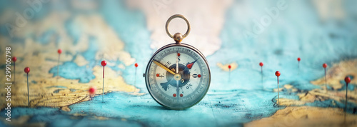 Fotomural Magnetic compass and location marking with a pin on routes on world map