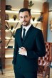 © GVS - Portrait of handsome elegant man in suit in modern interior