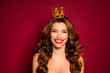 Photo of luxury model lady red lipstick on lips nude shoulders wearing only golden crown toothy smiling dreaming of prom isolated burgundy color background