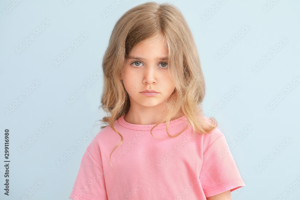 Sad little girl on light background