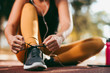 © JustLife - Young woman working out. Athlete woman getting ready for jogging.  Close up