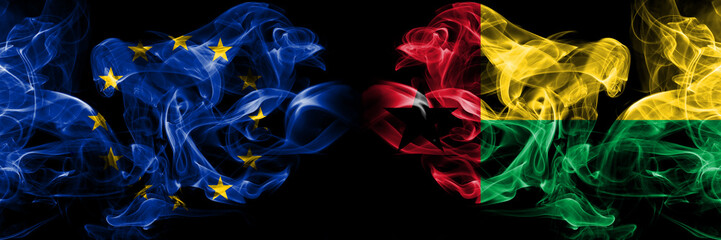 Eu, European union vs Guinea Bissau smoke flags placed side by side. Thick colored silky smokes abstract flags