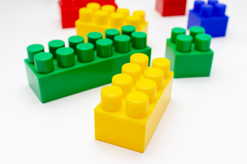 Many colorful toy plastic bricks, kit of blocks for building and constructing on white background, Children's game and playing concept