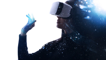 Double exposure of female face. Abstract woman portrait. Digital art. Beautiful female in VR helmet scrolling invisible screen while interacting with virtual reality under neon light.