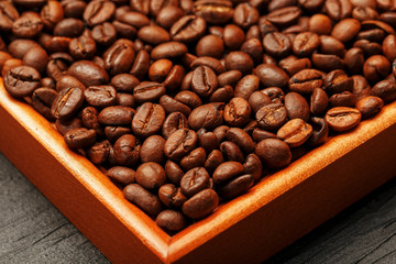 Fresh and aromatic roasted coffee beans in two wooden box, can be used as background.