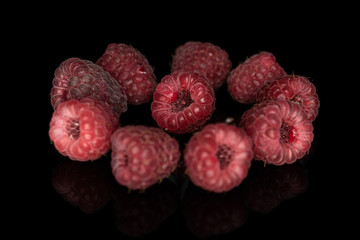 Wall Mural - Lot of whole fresh crimson raspberry isolated on black glass