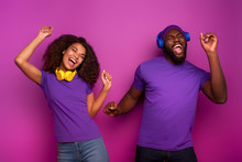 Couple With Headset Listen To Music And Dance With Energy On Violet Background