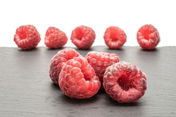 Group of two whole fresh crimson raspberry with steel spoon isolated on white background