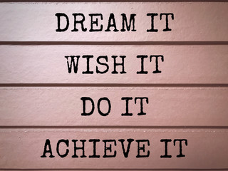 Wall Mural - Motivational and inspirational wording - Dream It, Wish It, Do It, Achieve It written on wooden plates.