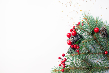 Christmas composition flatlay. Spruce branches, red berries on white background with space for text