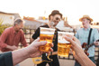 © beavera - Friends making a toast over their friendship. Young people holding cups of lager beer and cheering for their love. Cold beverage party concept.Happy couple having fun while drinking beer outdoors.