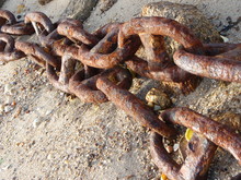 Large Rusty Chains On Beach