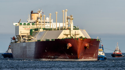 Lng tanker assisted by tug boats entering the port	