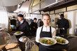 © JackF - Waitress in restaurant kitchen with ordered meals