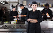 © JackF - Confident female chef with a team of cooks in restaurant kitchen