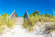 Wooden Stairs Over Sand Dune And Grass At The Beach In Florida USA