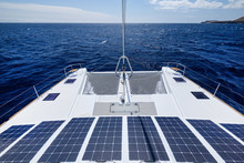 Luxury Solar Powered Catamaran, Fully Sustainable And Powered By Solar Energy, Charging Batteries Aboard A Sailboat, Vessel In Ocean Waters, Nobody. Photovoltaic Panels Renewable Eco Energy Concept
