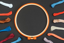 Embroidery Hoop With Multicolor Threads For Needlework And Sewing On Black Background. Embroidery Accessories Concept, Mock-up With Copy Space. Flat Layout, Top View.