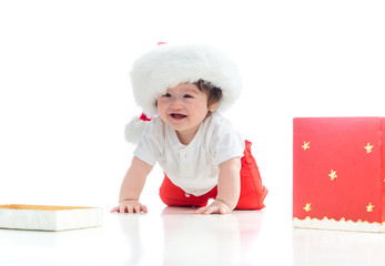 Wall Mural - Baby boy with a Santa hat with a Christmas present box