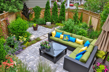 A Beautiful Small, Urban Backyard Garden Featuring A Tumbled Paver Patio, Flagstone Stepping Stones, And A Variety Of Trees, Shrubs And Perennials Add Colour And Year Round Interest. 