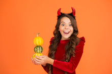 Happy Halloween Wishes. Happy Child Hold Pumpkins Orange Background. Little Child Smile With Red Devil Horns. Happy Autumn Holidays. Happy Celebration