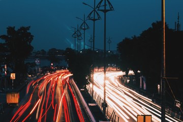 Wall Mural - Street with car headlights in the night