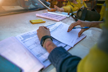 Construction Coal Miner Supervisor Conducting Safety Checking On Job Hazards Analysis On Hot Work Permit Before Sign Off Approval To Work On  Open Field Construction Coal Mine Site Sydney, Australia 
