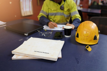 Wall Mural - defocused of miner seating on the chair written job hazard analysis (jsa) with jsa templates forms o