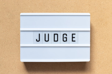 Canvas Print - White lightbox with word judge on wood background