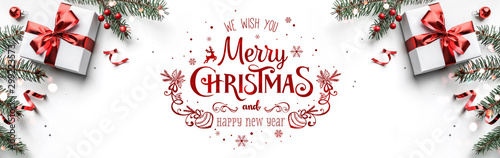 Merry Christmas text on white background with gift boxes, ribbons, red decoration, fir branches, bokeh, sparkles and confetti Poster Mural XXL