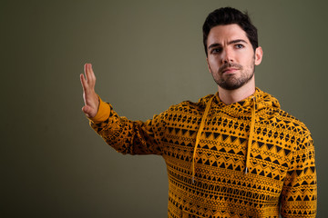 Wall Mural - Portrait of young handsome man wearing hoodie