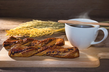 Wall Mural - chocolate twist bread and coffee on table