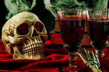 Halloween Backdrop, Haunted House And Vampire Drink Conceptual Idea With Skull, Glass Filled With Blood, Spiderwebs, Vintage Books And Skeleton Arm On Black Background