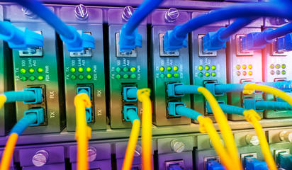 Fiber Optic cables connected to an optic ports and Network cables connected to ethernet ports