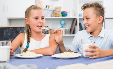 Wall Mural - Girl is feeding her brother